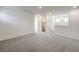 Spacious loft area with grey carpet and multiple windows at 2642 Snapdragon Falls Ave # 93, North Las Vegas, NV 89081