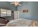 Bedroom with a queen bed and access to backyard at 2715 Coral Cliffs Ct, North Las Vegas, NV 89031