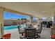 Covered patio with pool and seating area at 2715 Coral Cliffs Ct, North Las Vegas, NV 89031