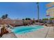 Relaxing kidney-shaped pool with waterfall feature in a desert landscape at 2715 Coral Cliffs Ct, North Las Vegas, NV 89031