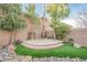 Landscaped backyard with tiered patio and artificial turf at 2768 Liberation Dr, Henderson, NV 89044