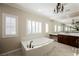 Spa-like bathroom featuring a large soaking tub and double vanity at 2768 Liberation Dr, Henderson, NV 89044