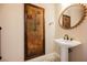 Powder room with pedestal sink and decorative mirror at 2768 Liberation Dr, Henderson, NV 89044