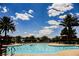 Relaxing community pool with palm trees and lounge chairs at 2768 Liberation Dr, Henderson, NV 89044