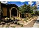 Beautiful building exterior with desert landscaping, an arched entrance, and manicured bushes at 2768 Liberation Dr, Henderson, NV 89044