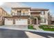 Two-story house with stone accents, three-car garage, and balcony at 2768 Liberation Dr, Henderson, NV 89044