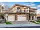 House exterior showcasing stone and stucco, three-car garage, and landscaping at 2768 Liberation Dr, Henderson, NV 89044