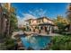 Luxury home with inviting pool, spacious patio, and lush landscaping at 2768 Liberation Dr, Henderson, NV 89044