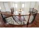 Curved staircase with wrought iron railing and hardwood floors at 2768 Liberation Dr, Henderson, NV 89044