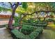 Lush garden with boxwood hedges and mature trees at 3074 Monte Rosa Ave, Las Vegas, NV 89120