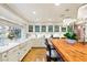 Bright kitchen with white cabinets, a large island, and a farmhouse sink at 3074 Monte Rosa Ave, Las Vegas, NV 89120