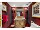 Elegant powder room with ornate vanity and rich red walls at 3074 Monte Rosa Ave, Las Vegas, NV 89120