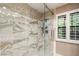 Large walk-in shower with marble tile and glass enclosure at 3074 Monte Rosa Ave, Las Vegas, NV 89120