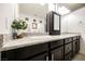 Double vanity bathroom with granite countertop and dark cabinetry at 3096 Beaux Art Ave, Henderson, NV 89044