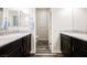 Double vanity bathroom with granite counters and dark cabinets at 3096 Beaux Art Ave, Henderson, NV 89044