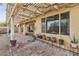 View of a covered back patio featuring brick flooring and several potted plants at 3363 Blue Ribbon Downs St, Las Vegas, NV 89122