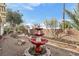 Charming backyard featuring a tiered fountain and gravel landscaping, creating a peaceful retreat at 3363 Blue Ribbon Downs St, Las Vegas, NV 89122