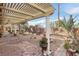 Beautiful backyard with a covered patio, mature landscaping, and serene garden area at 3363 Blue Ribbon Downs St, Las Vegas, NV 89122