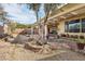 Spacious backyard with fountain, covered patio, and lush landscaping, perfect for relaxation and entertaining at 3363 Blue Ribbon Downs St, Las Vegas, NV 89122