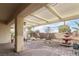 Covered patio with brick pavers offering a view of a landscaped backyard with water feature at 3363 Blue Ribbon Downs St, Las Vegas, NV 89122