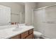 Neutral toned bathroom featuring a sink, vanity with wood cabinets, toilet, and stand up shower at 3363 Blue Ribbon Downs St, Las Vegas, NV 89122