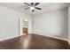 Spacious bedroom featuring wood floors, ceiling fan, and ensuite bathroom access at 3363 Blue Ribbon Downs St, Las Vegas, NV 89122