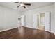 Bright bedroom with hardwood floors and doorways to the bathroom and kitchen at 3363 Blue Ribbon Downs St, Las Vegas, NV 89122