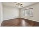 Bedroom featuring a ceiling fan, hardwood floors, base trim, and a large window at 3363 Blue Ribbon Downs St, Las Vegas, NV 89122