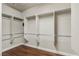 Walk-in closet featuring custom built-in shelving and wooden floors at 3363 Blue Ribbon Downs St, Las Vegas, NV 89122