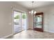 Dining area with a sliding door to the patio, a chandelier, and cabinet at 3363 Blue Ribbon Downs St, Las Vegas, NV 89122