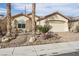 Single-story home with desert landscaping, a two-car garage, and a paved brick driveway at 3363 Blue Ribbon Downs St, Las Vegas, NV 89122