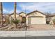 Charming single-story home featuring a two-car garage, desert landscaping, and a paved brick driveway at 3363 Blue Ribbon Downs St, Las Vegas, NV 89122