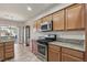 Well-lit kitchen with stainless appliances, granite counters, and adjacent dining area perfect for entertaining at 3363 Blue Ribbon Downs St, Las Vegas, NV 89122