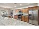 Modern kitchen featuring granite counters, stainless appliances, and ample cabinetry for storage at 3363 Blue Ribbon Downs St, Las Vegas, NV 89122