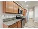 Modern kitchen with stainless steel appliances and sleek granite countertops at 3363 Blue Ribbon Downs St, Las Vegas, NV 89122