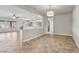 Open-concept living room with tile flooring, ceiling fan, natural lighting, and view to kitchen at 3363 Blue Ribbon Downs St, Las Vegas, NV 89122