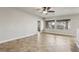 Bright living room with tile floors, a ceiling fan, and large windows at 3363 Blue Ribbon Downs St, Las Vegas, NV 89122