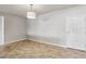 Bright, empty living space with ceramic tile, light fixture and white door at 3363 Blue Ribbon Downs St, Las Vegas, NV 89122