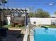 Inviting backyard with a sparkling pool, pergola, and seating area at 3712 San Joaquin Ave, Las Vegas, NV 89102