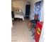 Small bedroom with a bed, chair, and mini-fridge at 3712 San Joaquin Ave, Las Vegas, NV 89102