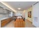 Modern kitchen with stainless steel appliances, sleek cabinetry, a central island, and dining table, bathed in natural light at 3726 Las Vegas Blvd # 2702, Las Vegas, NV 89158