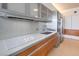 Sleek kitchen featuring stainless steel appliances, white countertops, and wood cabinetry with city view in the background at 3726 Las Vegas Blvd # 2702, Las Vegas, NV 89158