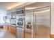 Close-up of modern stainless steel kitchen appliances and sleek wood grain cabinetry with city view in the background at 3726 Las Vegas Blvd # 2702, Las Vegas, NV 89158