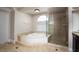 Bathroom with soaking tub, walk-in shower, and window at 3925 Larkcrest St, Las Vegas, NV 89129