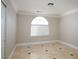 Bright bedroom with arched window and tile floors at 3925 Larkcrest St, Las Vegas, NV 89129