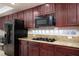 Modern kitchen with granite countertops and dark wood cabinets at 3925 Larkcrest St, Las Vegas, NV 89129