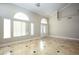 Spacious living room with high ceilings, tile floors, and large windows at 3925 Larkcrest St, Las Vegas, NV 89129