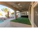 Covered patio with artificial turf and ceiling fans at 3925 Larkcrest St, Las Vegas, NV 89129