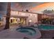 Inviting swimming pool and spa surrounded by a stone patio at 3925 Larkcrest St, Las Vegas, NV 89129