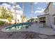 Inviting kidney shaped pool with a spacious patio and landscaping at 3925 Larkcrest St, Las Vegas, NV 89129